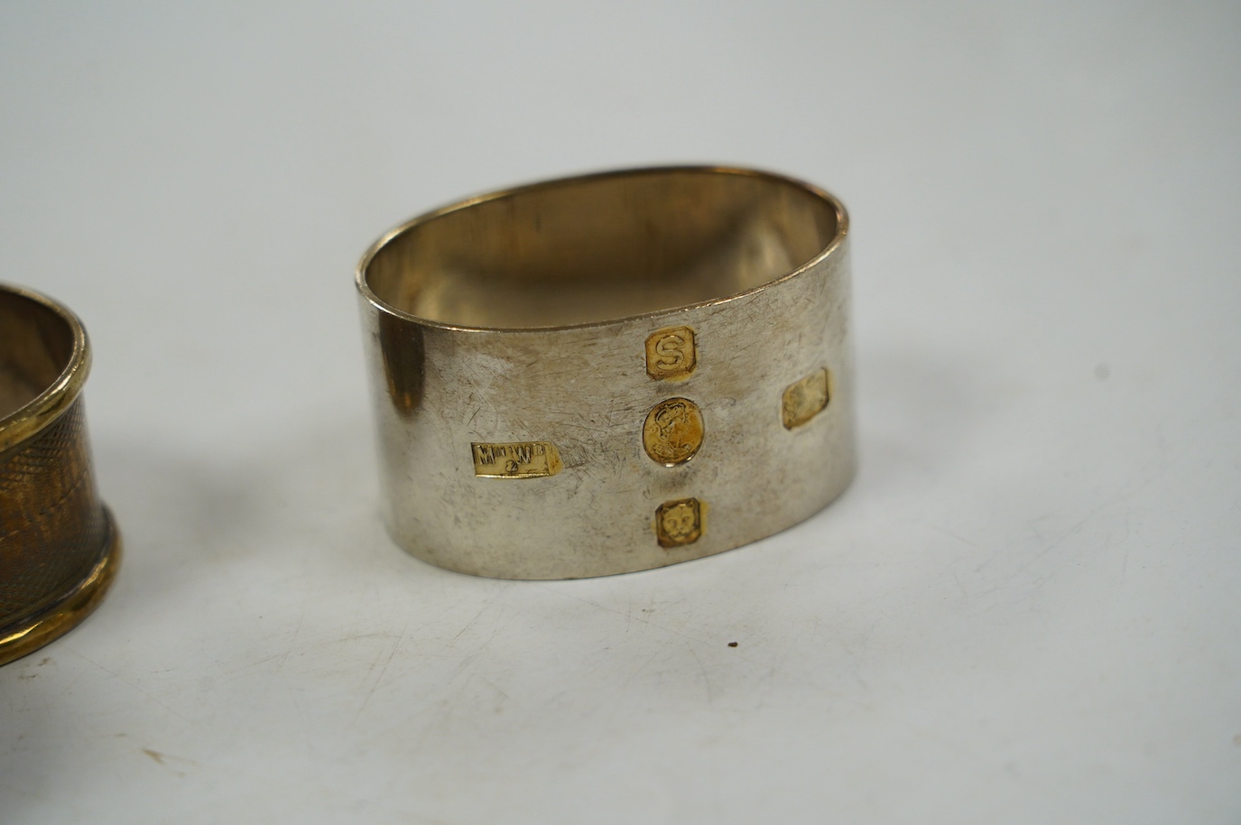 Eight assorted silver napkin rings, including a pair, Birmingham, 1937 and four plated napkin rings. Condition - fair